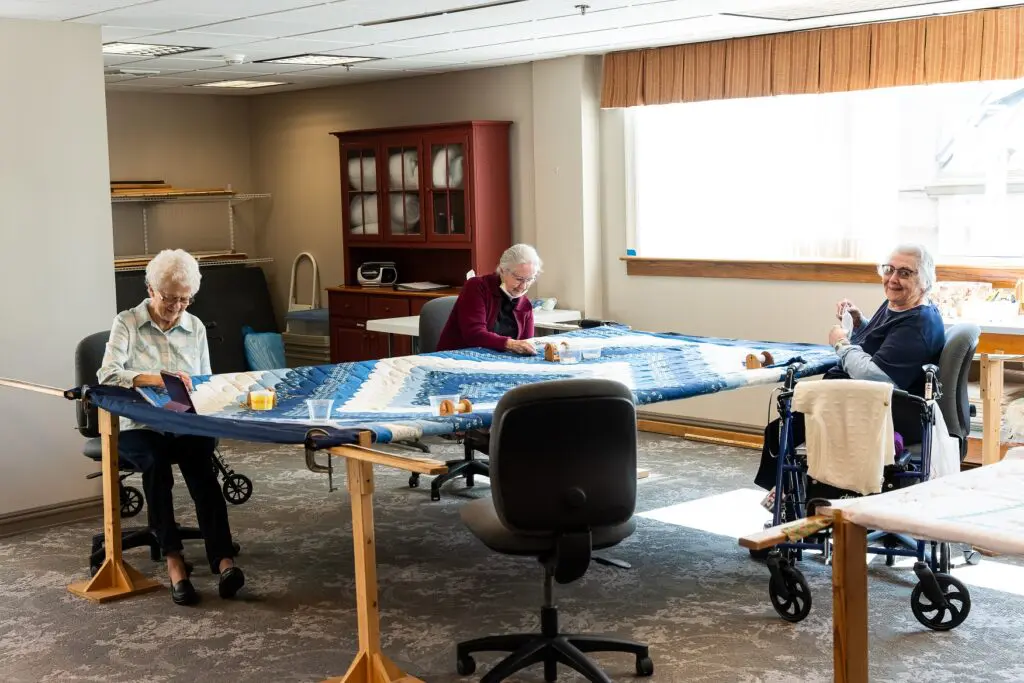 Senior living residents work together in the quilting room at Souderton Mennonite Homes.