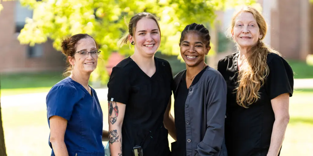 Four team members in scrubs who serve residents in the skilled nursing unit at Dock Woods, one of three Living Branches communities