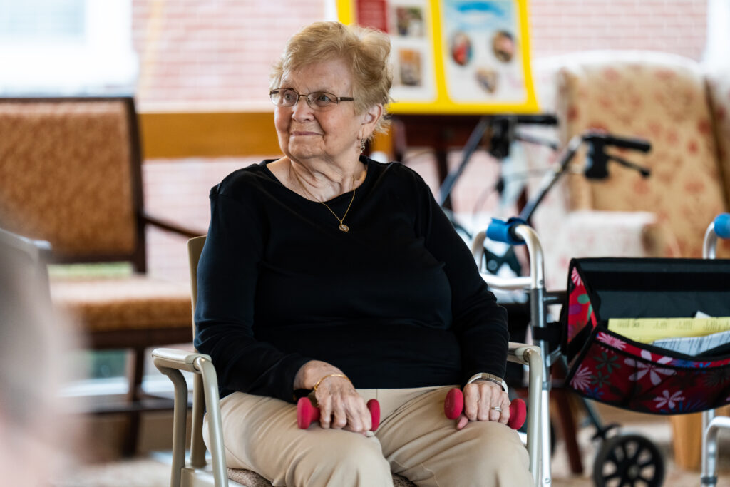 A resident uses hand weights during a group class at The Willows personal care home in Hatfield, PA.