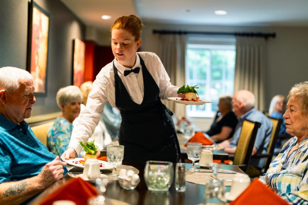 A server brings delicious restaurant-quality food to residents at Dock Woods in Lansdale