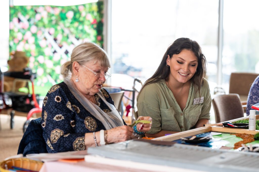 An art therapy intern engages a resident at The Willows of Living Branches in Hatfield